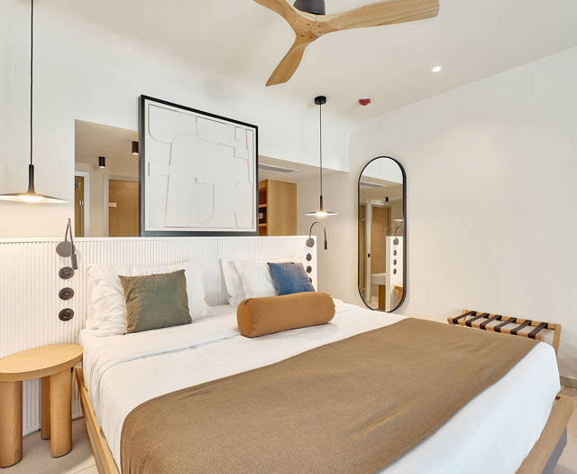 Junior suite with stylish lighting, warm tones, and modern furniture