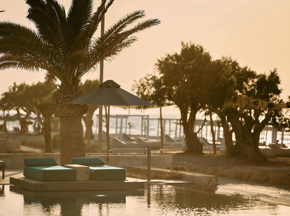Paralos Kosta Alimia pool's green sunbeds and the beach in the background