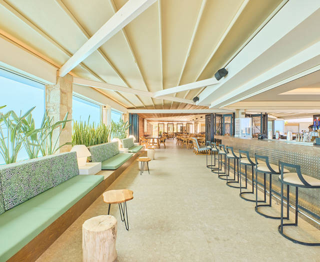 Paralos Kosta Alimia Pool Bar couches with small tables and the bar