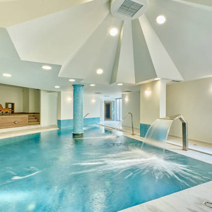 Indoor spa pool with hydrotherapy features.