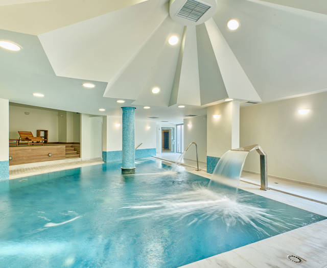Indoor spa pool with hydrotherapy features.