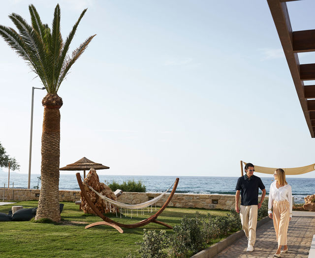 Couple enjoy walking in Kosta Alimia's gardened areas