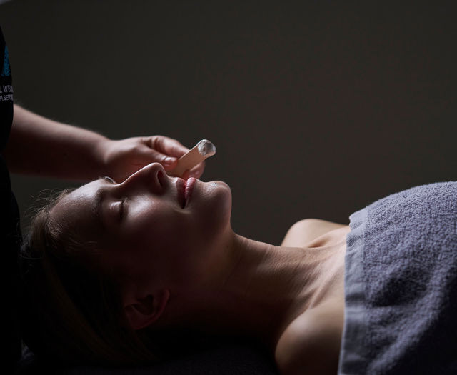 A guest indulging in a rejuvenating facial treatment at the serene spa of Kosta Alimia