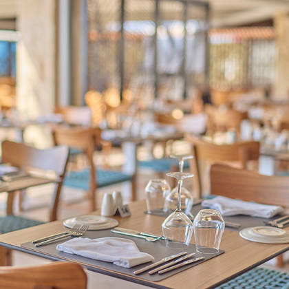 Cozy and elegant seafood restaurant interior with wooden furniture and tables set for dining.