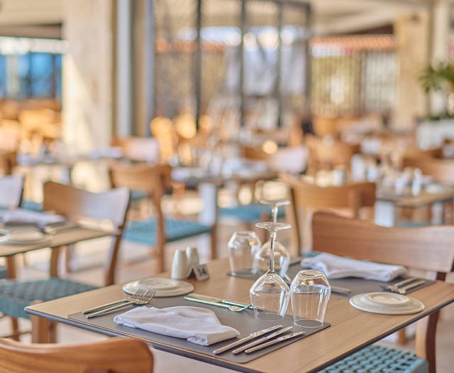 Cozy and elegant seafood restaurant interior with wooden furniture and tables set for dining.