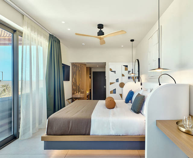 Retreat room with sea view, modern decor, and sliding doors leading to a private outdoor lounge.