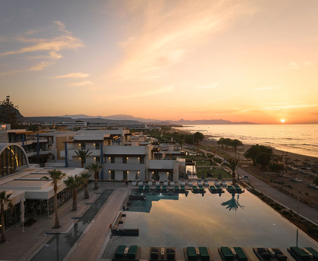 Aerial side view of Kosta Alimia pool and beach view at sunset.