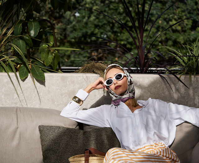 Guest relaxing in style at Kosta Alimia’s lush outdoor lounge
