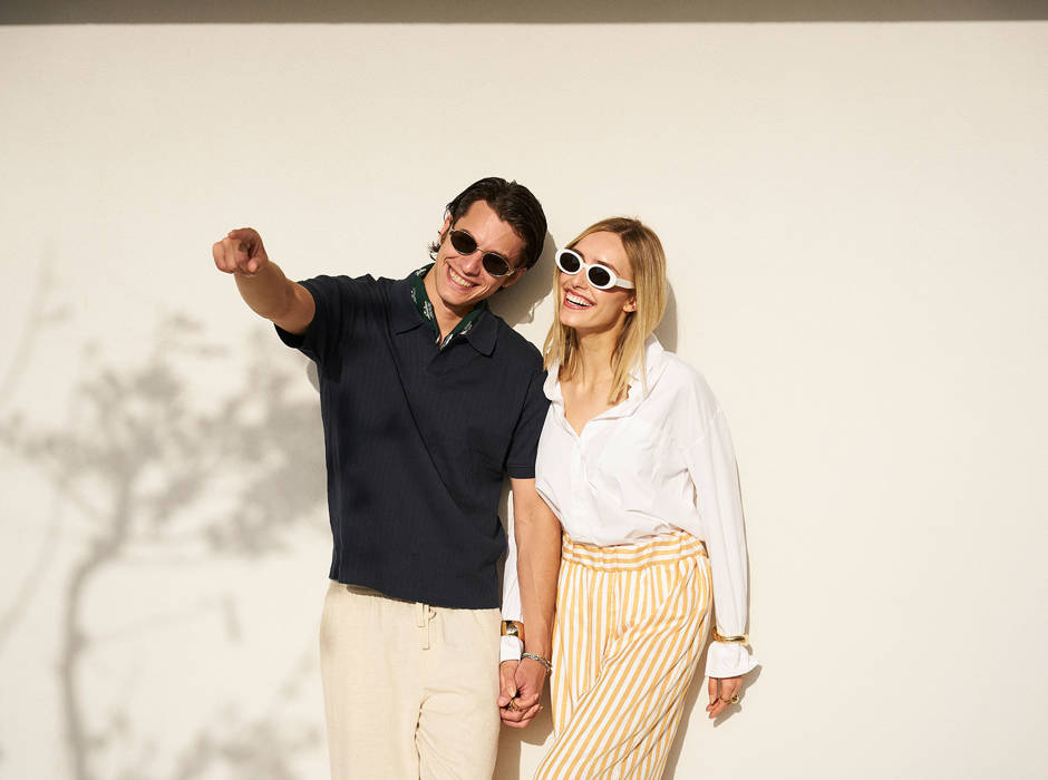 Smiling couple holding hands and enjoying the sun at Kosta Alimia