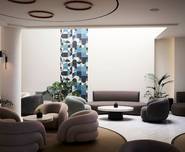 Lounge area of the Kosta Alimia with sofas, coffee tables, and warm ambient lighting