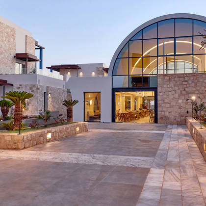 Kosta Alimia exterior view of a hotel building at sunset