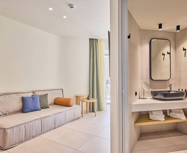 Suite bathroom modern area with black modern sink, a large mirror and build in shelves and a view in the room